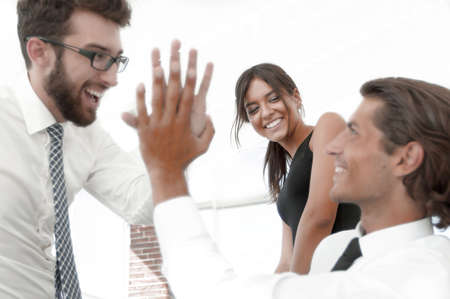 business colleagues giving each other high five.の写真素材