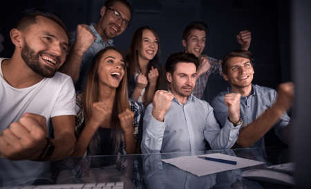happy business team looking at computer monitorの写真素材