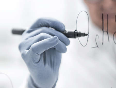 background image.scientist making notes on a transparent Board
