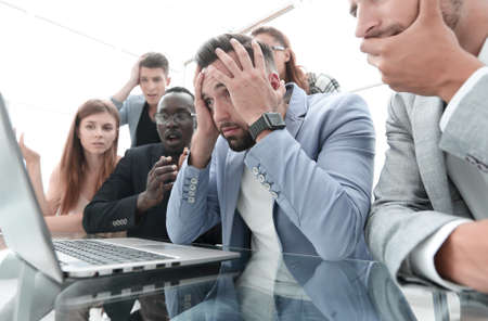 businessmens looking stressed in front of a laptopの写真素材
