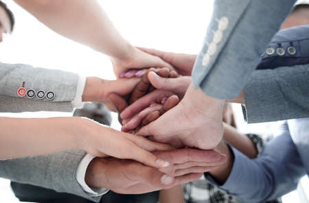 Closeup of a business colleagues with their hands stacked togeth