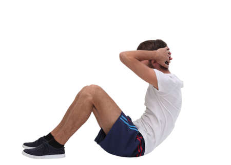 young man performs physical exerciseの写真素材