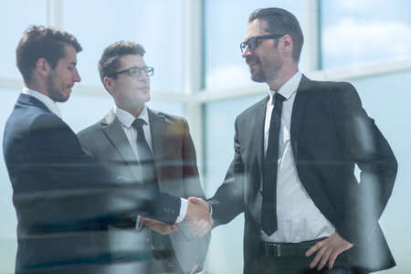 handshake business partners in a modern office