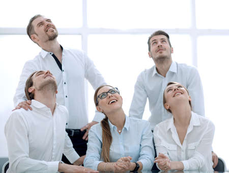 young business team looks up somewhereの写真素材