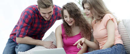 group of students sitting on the sofa in the living room.
