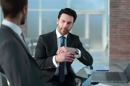 two businessmen sitting at the office tableの写真素材