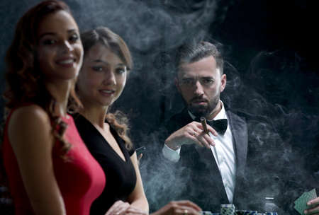 Upper class friends gambling in a casino.の写真素材