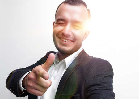 Happy successful businessman pointing on copy space