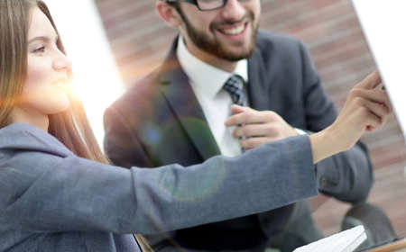 colleagues discussing information on a computerの写真素材