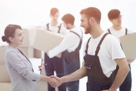 Manager with clipboard shaking hands with movers.の写真素材
