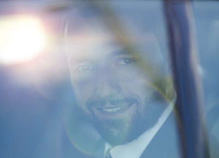 Because of a glass of smiling businessman in the back seat of a car.