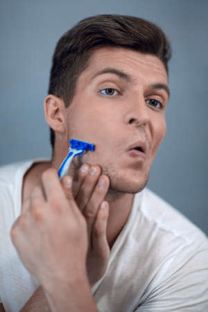 close up. stylish modern guy shaves his face