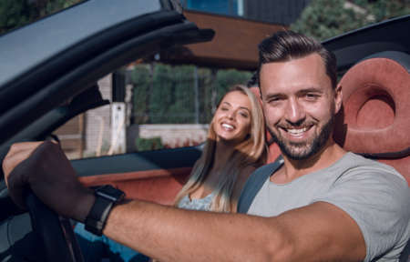 close up.a handsome man driving a luxury car
