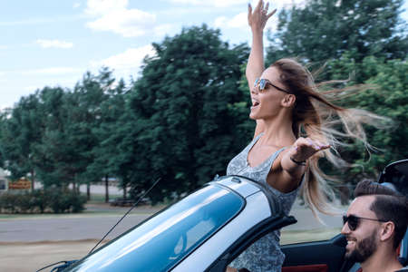 stylish girl enjoying a ride in a convertible car