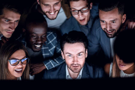 close-up of businessman and business team looking at computer monitor