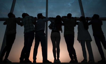 business team looks at the copy space through the office windowの写真素材