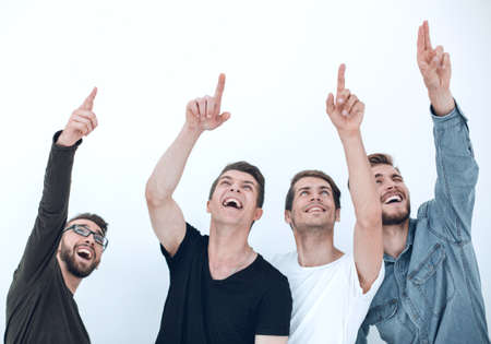 A group of people raises their hands up and points