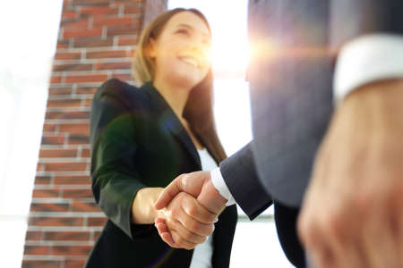 Close up of businessman and businesswoman shaking hands