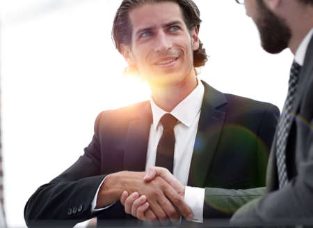 confident handshake colleagues in the office