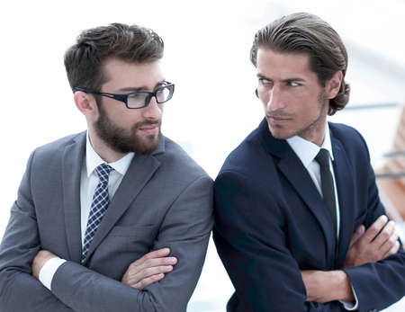 Two men standing back to back and support each otherの写真素材