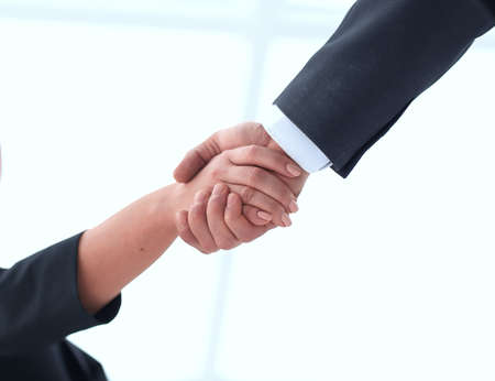 closeup of business woman shaking hands with her business partner.の写真素材