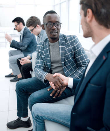handshake of business people sitting in the office lobbyの写真素材
