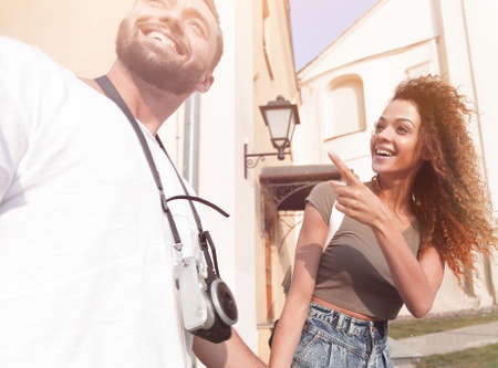 A couple is walking along the streets of the city and having funの写真素材