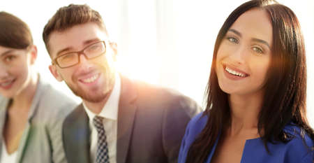 Business woman smiling with her colleagues in the backgroundの写真素材