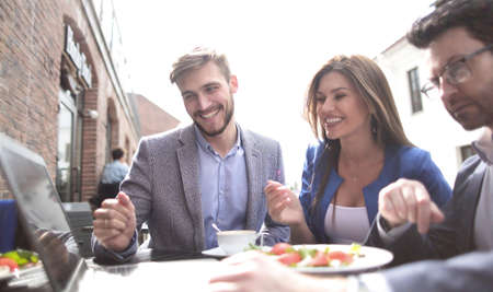 business colleagues sitting at a table in a cafe