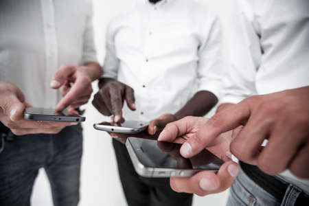 close up.a group of young people using their smartphonesの写真素材
