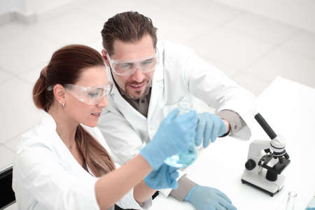 two chemists working with different liquids in tubesの写真素材