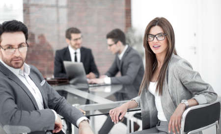 businessman and business woman sitting at the Desk