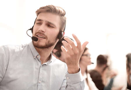 call center employee talking with a colleague in the officeの写真素材