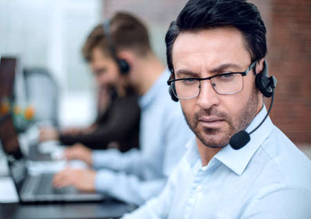 close up.call center operator on the background of the office