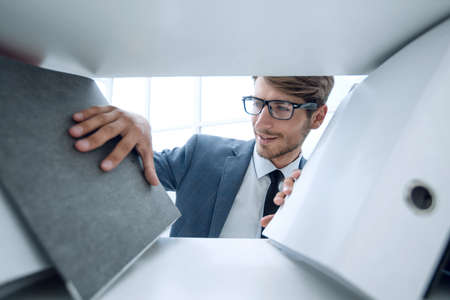 smiling man looking at documentsの写真素材