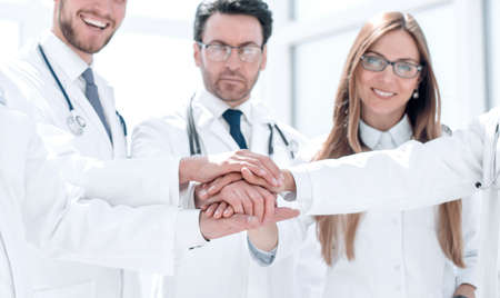 group of doctors with their hands folded togetherの写真素材
