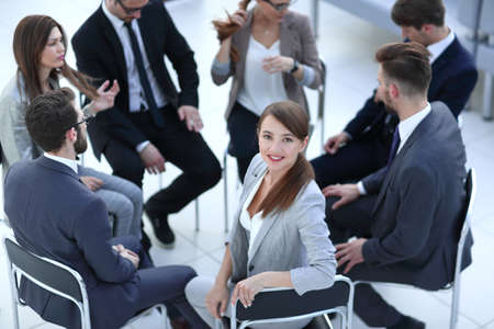 young business woman sitting in a circle of colleagues