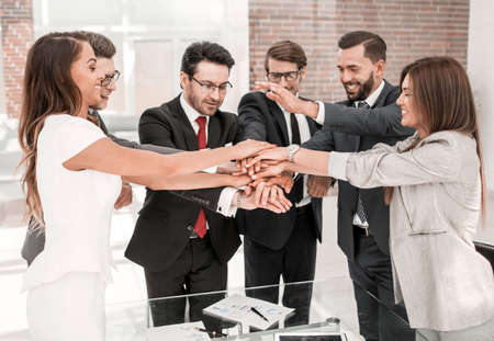professional business team making tower out of their handsの写真素材