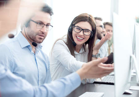 close up.smiling staff call centre to discuss business issues.