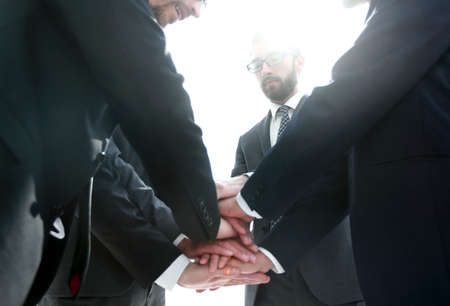 close up.business partners build a tower out of their handsの写真素材