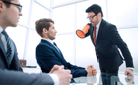 businessman screaming at employee at the time of the meeting.の写真素材