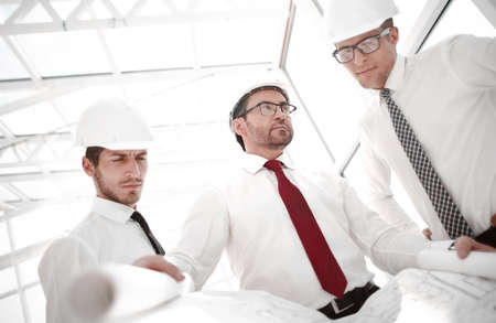 three architects discussing sketches for a new project