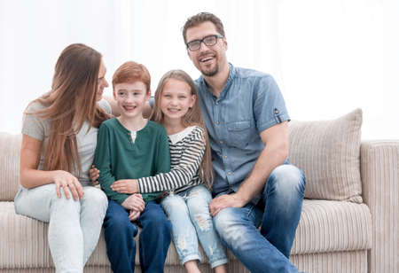 happy family sitting on the couch in the living room.