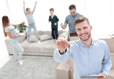 smiling realtor with keys on the background of a new apartmentの写真素材