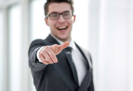 close up.smiling young businessman pointing at you.の写真素材