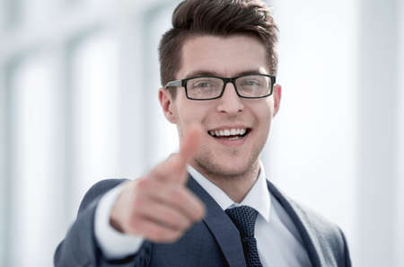 close up.smiling young businessman pointing at you.の写真素材