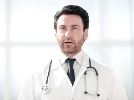 portrait of serious doctor on blurred backgroundの写真素材
