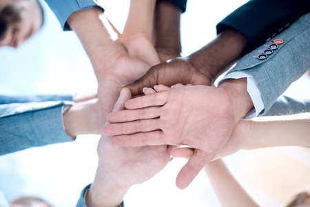 Low angle view of fit people stacking hands