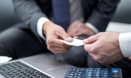 close up.the businessman gives the business partner a business cの写真素材