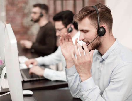 employees with a headset in the workplace in the business centerの写真素材